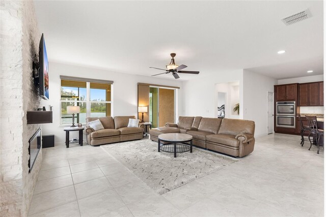 3936 Parkhouse Dr, Orlando, FL 32824 - living area with recessed lighting, light tile patterned floors, ceiling fan, visible vents, and a stone fireplace
