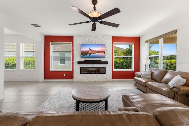 3936 Parkhouse Dr, Orlando, FL 32824 - living area with a large fireplace, visible vents, baseboards, ceiling fan, and tile patterned flooring