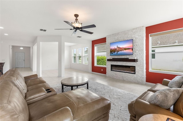 3936 Parkhouse Dr, Orlando, FL 32824 - tiled living room featuring a large fireplace, visible vents, and a ceiling fan
