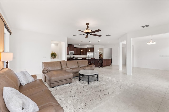 3936 Parkhouse Dr, Orlando, FL 32824 - living area with light tile patterned floors, visible vents, recessed lighting, and ceiling fan with notable chandelier