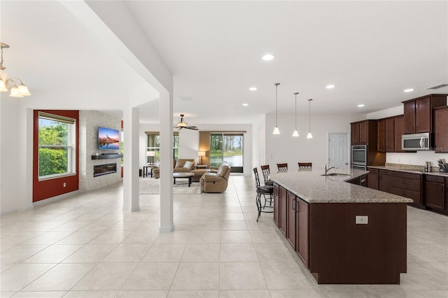 3936 Parkhouse Dr, Orlando, FL 32824 - kitchen with a sink, stainless steel appliances, a healthy amount of sunlight, and dark brown cabinetry