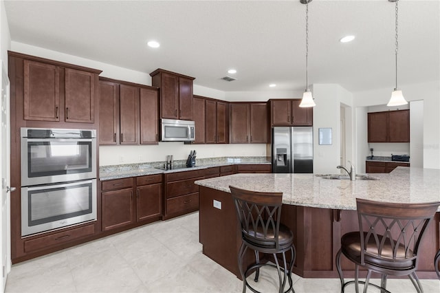 3936 Parkhouse Dr, Orlando, FL 32824 - kitchen with recessed lighting, a spacious island, a sink, visible vents, and appliances with stainless steel finishes