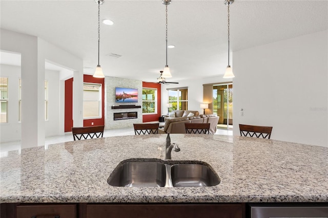 3936 Parkhouse Dr, Orlando, FL 32824 - kitchen with open floor plan, hanging light fixtures, a sink, and ceiling fan