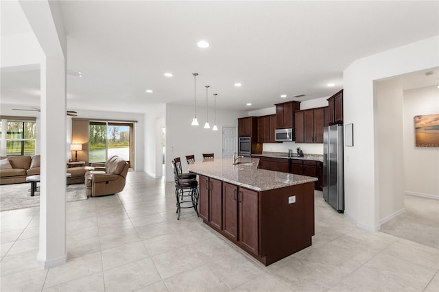 3936 Parkhouse Dr, Orlando, FL 32824 - kitchen featuring a sink, stainless steel appliances, dark brown cabinets, and open floor plan