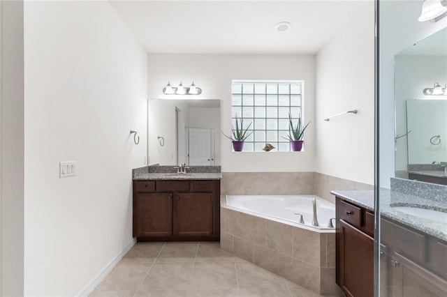 3936 Parkhouse Dr, Orlando, FL 32824 - bathroom with tile patterned flooring, a sink, two vanities, and a bath