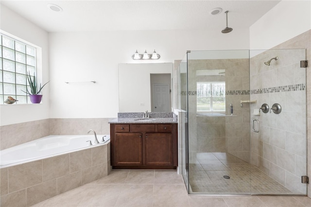 3936 Parkhouse Dr, Orlando, FL 32824 - full bathroom with a garden tub, a stall shower, tile patterned floors, and vanity