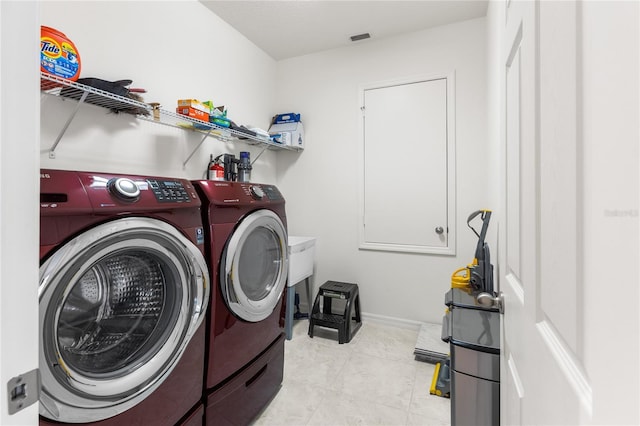 3936 Parkhouse Dr, Orlando, FL 32824 - clothes washing area featuring tile patterned floors, washing machine and dryer, laundry area, and visible vents