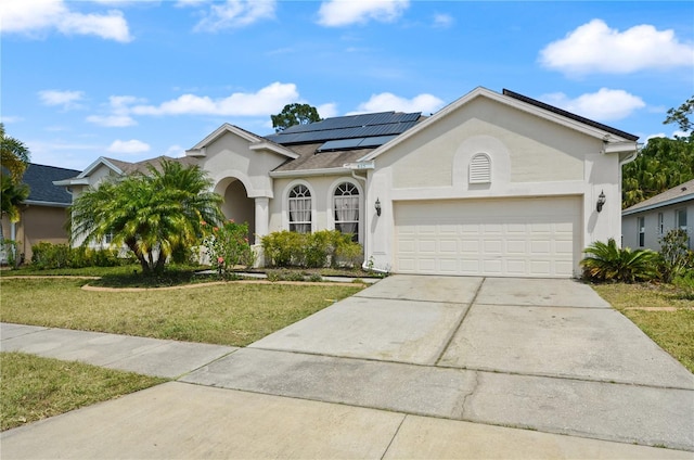 625 Waterland Ct, Orlando, FL 32828 - ranch-style house with a front lawn, solar panels, stucco siding, and concrete driveway