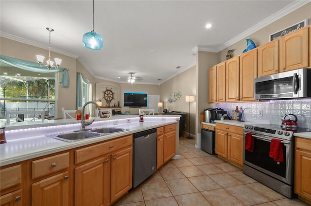 625 Waterland Ct, Orlando, FL 32828 - kitchen with crown molding, light countertops, a sink, tasteful backsplash, and stainless steel appliances