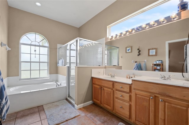 625 Waterland Ct, Orlando, FL 32828 - full bathroom with tile patterned floors, a sink, a stall shower, double vanity, and a bath
