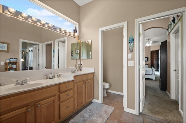 625 Waterland Ct, Orlando, FL 32828 - ensuite bathroom featuring connected bathroom, tile patterned floors, toilet, a sink, and ceiling fan
