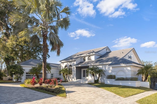 9000 Shawn Park Pl, Orlando, FL 32819 - view of front facade featuring decorative driveway and stucco siding