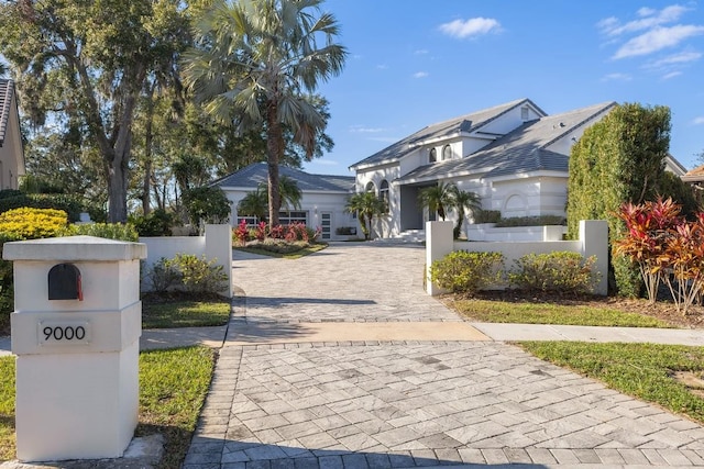 9000 Shawn Park Pl, Orlando, FL 32819 - view of front of house with decorative driveway and fence