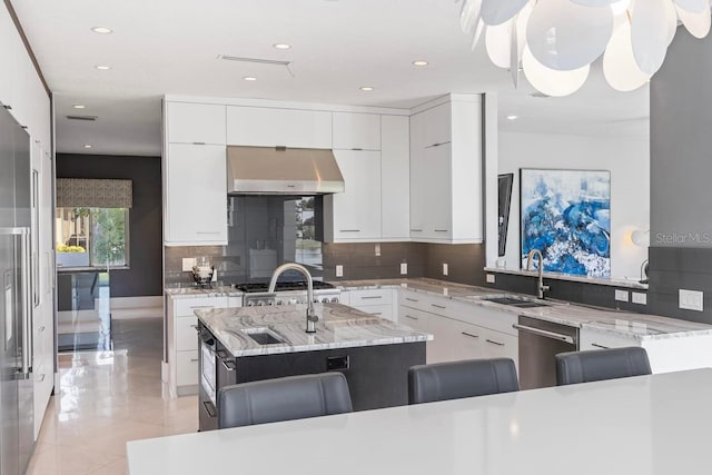 9000 Shawn Park Pl, Orlando, FL 32819 - kitchen featuring exhaust hood, stainless steel appliances, backsplash, a sink, and modern cabinets