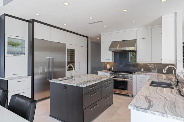 9000 Shawn Park Pl, Orlando, FL 32819 - kitchen featuring a sink, an island with sink, ventilation hood, high quality appliances, and light tile patterned floors