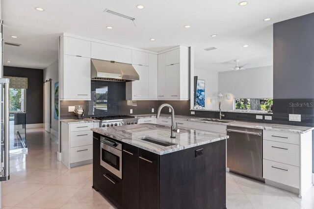 9000 Shawn Park Pl, Orlando, FL 32819 - kitchen featuring backsplash, a sink, exhaust hood, stainless steel appliances, and white cabinets