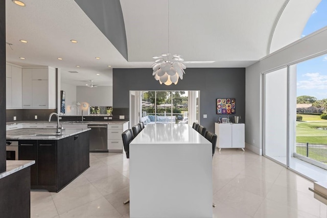 9000 Shawn Park Pl, Orlando, FL 32819 - kitchen with a wealth of natural light, a sink, stainless steel appliances, and a center island with sink