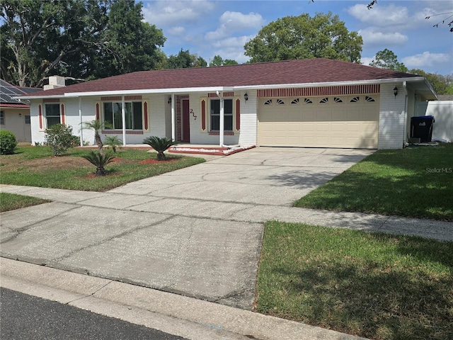 single story home with concrete driveway, covered porch, an attached garage, brick siding, and a front lawn