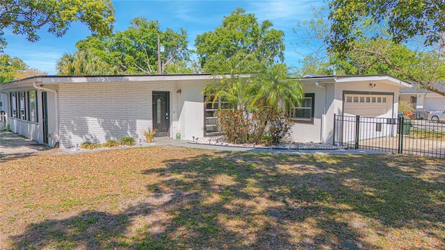 701 Denton Rd, Winter Park, FL 32792 - view of front facade with driveway, fence, a garage, a front lawn, and stucco siding