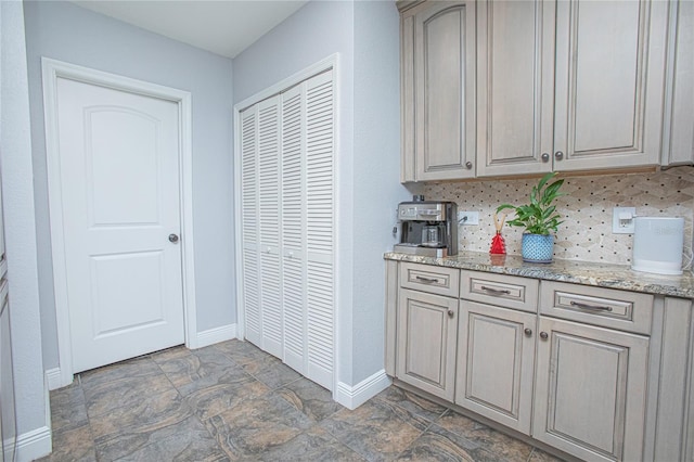 701 Denton Rd, Winter Park, FL 32792 - kitchen with baseboards, tasteful backsplash, stone finish flooring, and light stone countertops