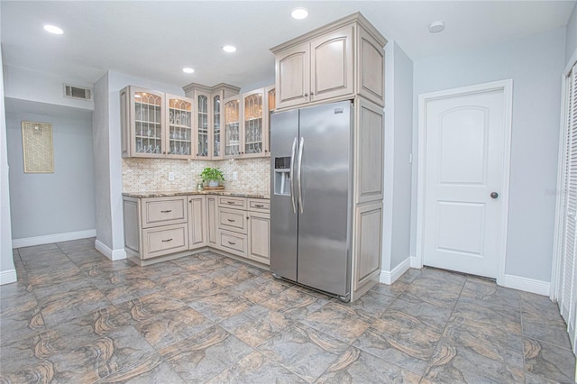 701 Denton Rd, Winter Park, FL 32792 - kitchen featuring backsplash, glass insert cabinets, stainless steel refrigerator with ice dispenser, baseboards, and visible vents