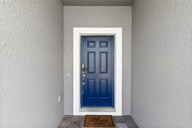 4305 Lana Ave, Davenport, FL 33897 - entrance to property featuring stucco siding