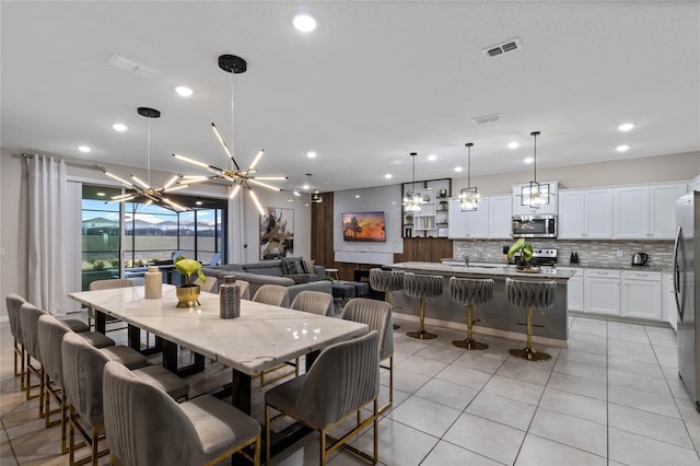 4305 Lana Ave, Davenport, FL 33897 - dining room featuring visible vents, an inviting chandelier, recessed lighting, and light tile patterned floors