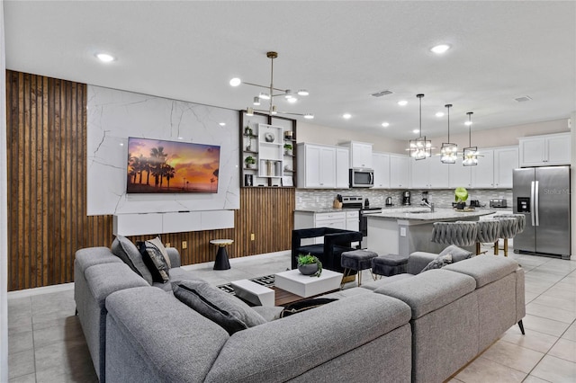 4305 Lana Ave, Davenport, FL 33897 - living room with recessed lighting, a notable chandelier, wooden walls, and visible vents