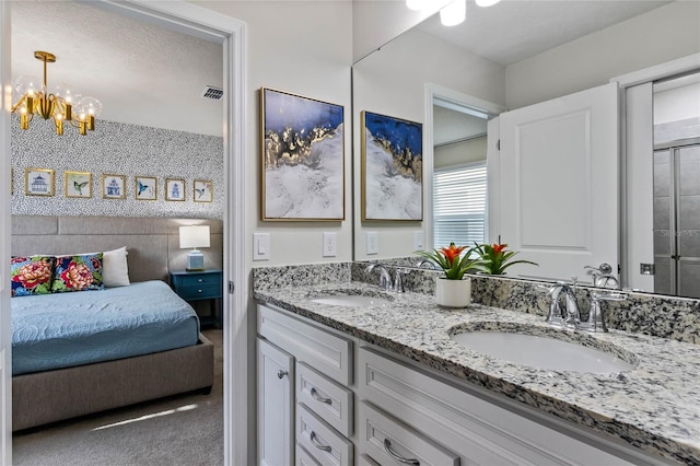 4305 Lana Ave, Davenport, FL 33897 - bathroom with double vanity, a sink, a notable chandelier, and visible vents