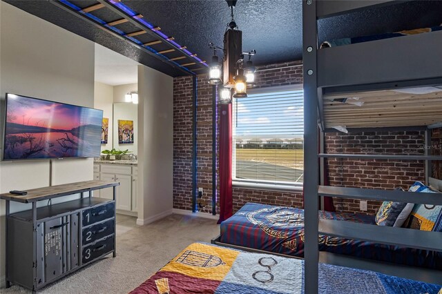 4305 Lana Ave, Davenport, FL 33897 - bedroom featuring light carpet, brick wall, and a textured ceiling