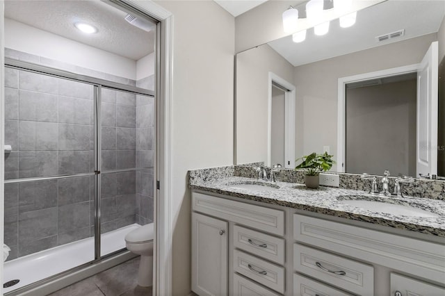 4305 Lana Ave, Davenport, FL 33897 - bathroom with visible vents, a sink, toilet, and a shower stall