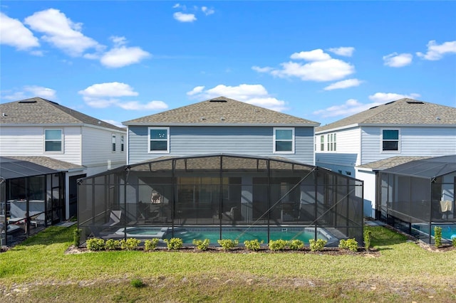 4305 Lana Ave, Davenport, FL 33897 - back of property featuring glass enclosure, a lawn, and an outdoor pool