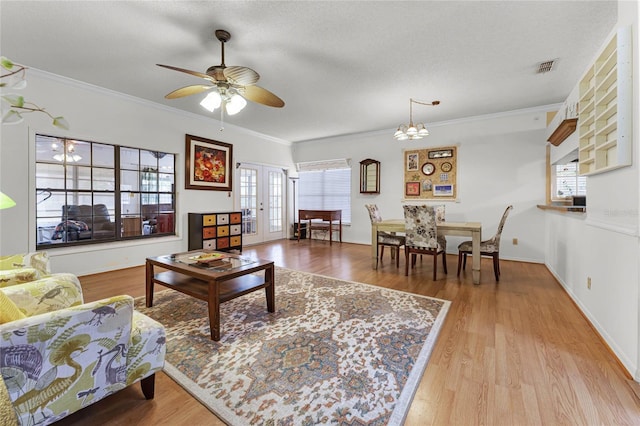 5813 Parkview Point Dr, Orlando, FL 32821 - living room featuring a wealth of natural light, wood finished floors, and ornamental molding