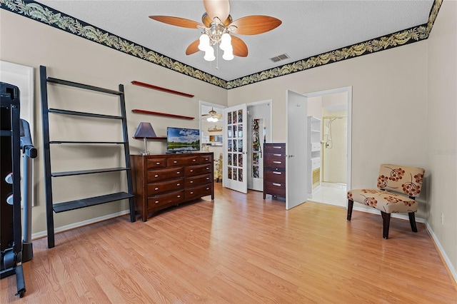 5813 Parkview Point Dr, Orlando, FL 32821 - interior space with a ceiling fan, a textured ceiling, light wood finished floors, and visible vents