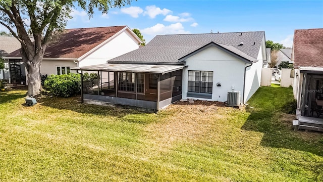 5813 Parkview Point Dr, Orlando, FL 32821 - back of house with a sunroom, a lawn, roof with shingles, stucco siding, and cooling unit