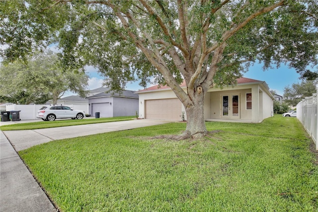 view of front of property featuring concrete driveway, a front yard, an attached garage, stucco siding, and french doors