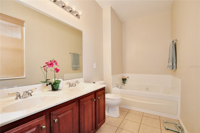 bathroom with a garden tub, toilet, a sink, and tile patterned floors