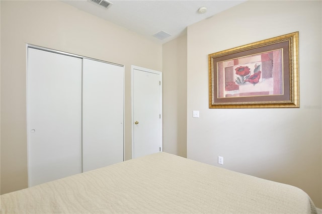 bedroom with visible vents and a closet