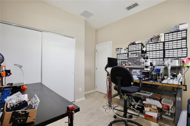 carpeted office space featuring visible vents and baseboards