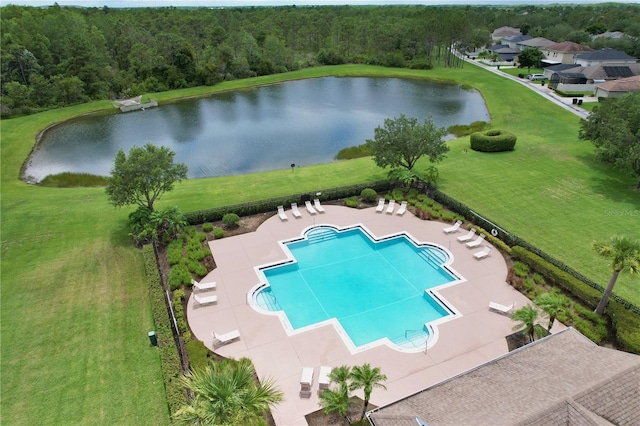community pool with a lawn, a patio, a water view, and a wooded view