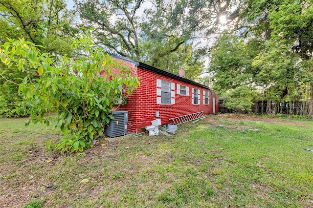 1413 36th St, Orlando, FL 32839 - view of side of property featuring cooling unit, fence, and a yard