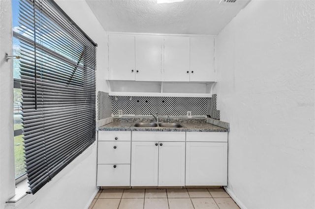 1413 36th St, Orlando, FL 32839 - kitchen featuring white cabinetry, a sink, and dark countertops