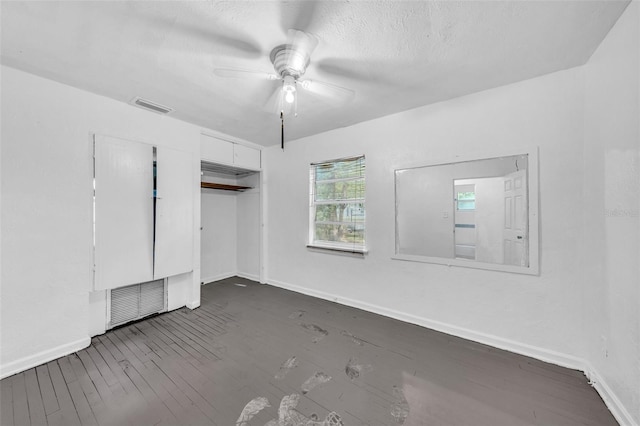 1413 36th St, Orlando, FL 32839 - unfurnished bedroom featuring dark wood-style floors, a closet, a textured ceiling, and visible vents