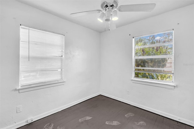 1413 36th St, Orlando, FL 32839 - empty room with dark wood-type flooring, baseboards, and a ceiling fan
