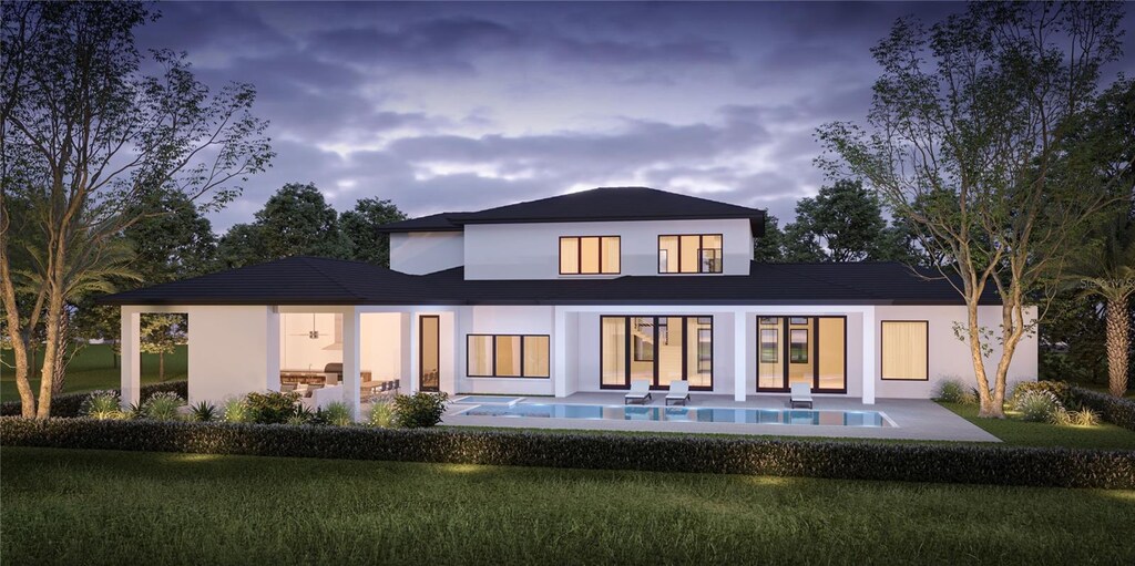 back of house at dusk featuring stucco siding, an outdoor pool, and a patio
