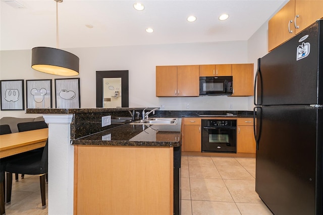 kitchen featuring light tile patterned floors, dark stone counters, a sink, visible vents, and black appliances
