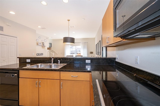 kitchen featuring cooktop, a sink, dishwasher, dark stone countertops, and recessed lighting