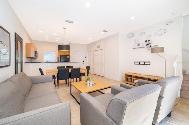 living area with light tile patterned flooring, visible vents, and recessed lighting