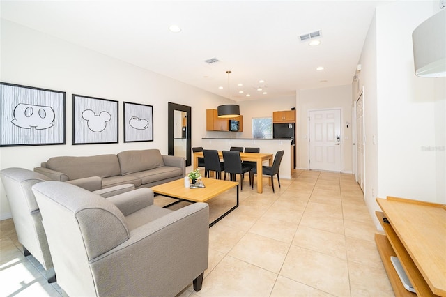 living room with light tile patterned flooring, visible vents, and recessed lighting