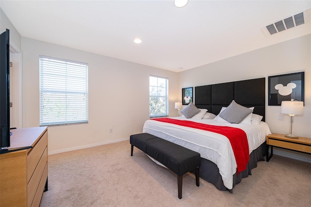 bedroom with recessed lighting, baseboards, light colored carpet, and visible vents